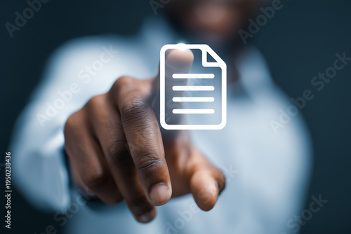 African American man pointing at glowing digital document icon, concept for paperless office and electronic data management