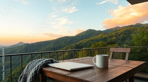 A serene balcony scene at sunrise, featuring a laptop and a mug on a wooden table, with a breathtaking view of rolling green mountains under a soft, pastel sky. The warm light creates a peaceful and i