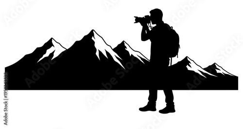 Silhouette of a photographer with a camera overlooking a mountain range