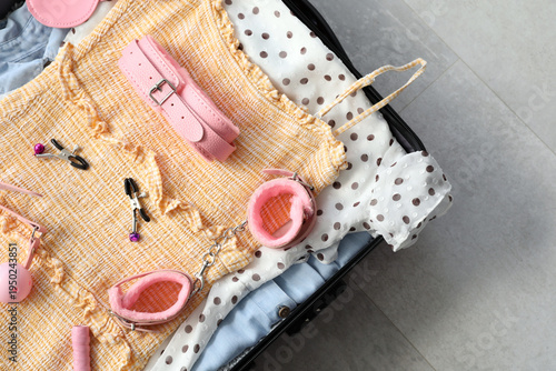 Open suitcase with female c...