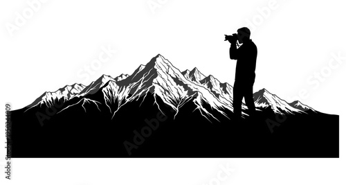 Silhouette of a photographer capturing a dramatic mountain range landscape