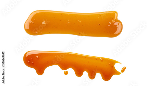 A close-up view of two golden liquid splatters on a black background