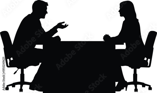 Silhouette of man and woman discussing business at desk