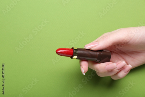 Female hand with red lipsti...