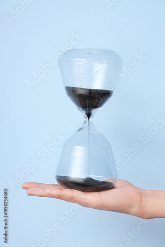 Female hand holding hourgla...