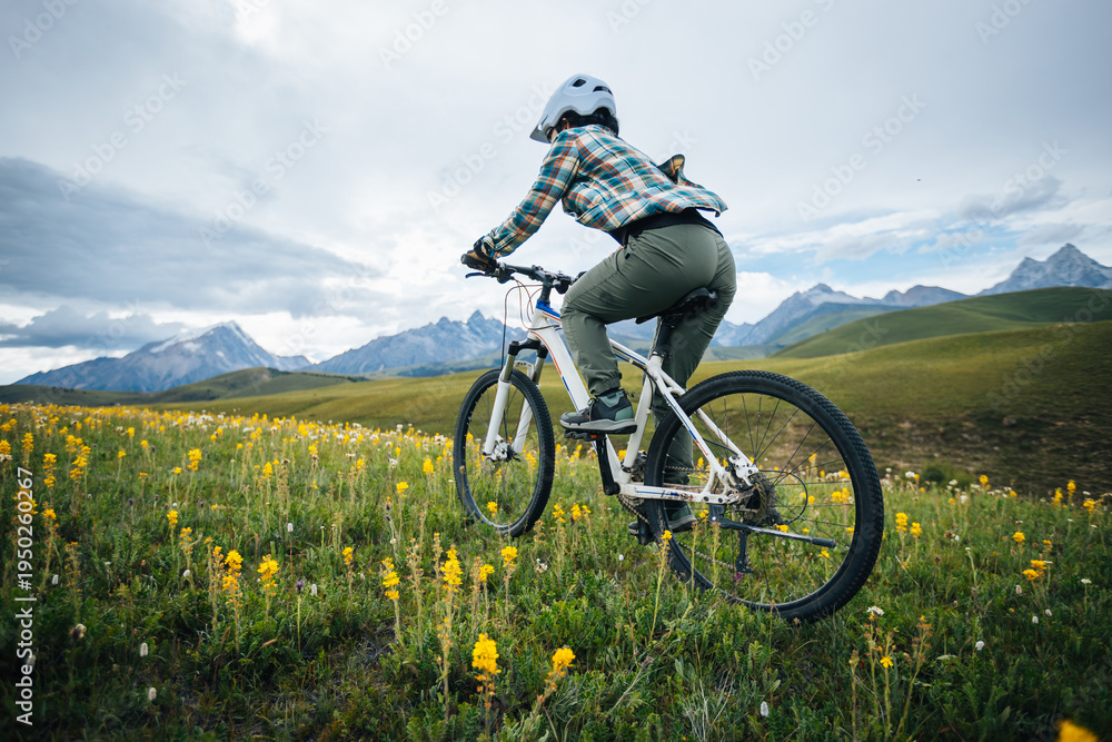 Obraz premium Riding mountain bike on the forest and grassland trail