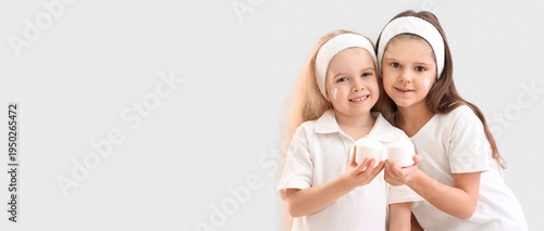Happy sisters with jars of ...