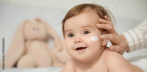 Mother applying cream on he...