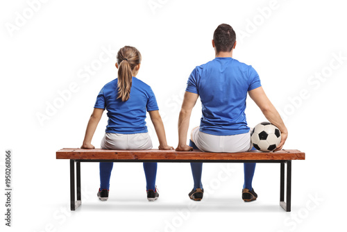 Rear view shot of a girl and football player sitting on a bench
