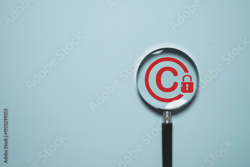 Copyright protection concept with copyright symbol and security lock in magnifier glass for creative thinking idea intellectual property rights protection, licensing law and digital patent ownership.