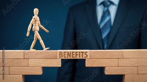 Wooden mannequin walking across a bridge made of blocks with benefits text representing employee compensation and corporate perks.