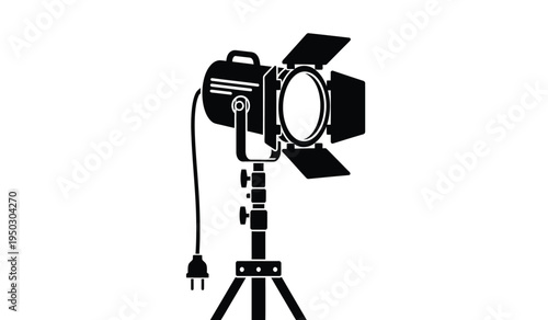 Professional studio spotlight with barn doors mounted on an adjustable metal tripod light stand