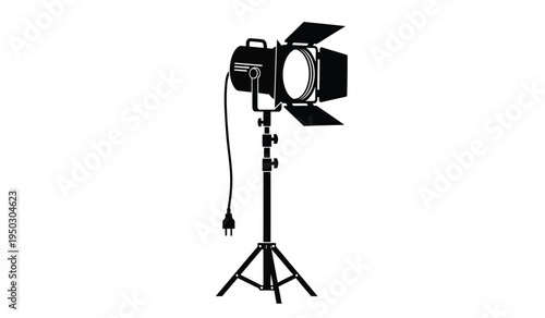 Professional film studio spotlight with barn doors mounted on an adjustable metal tripod stand