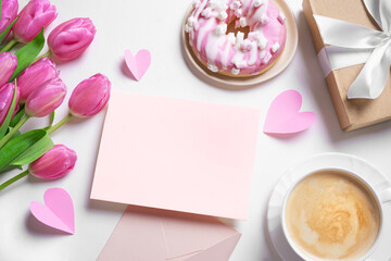 Happy Mother's Day concept flat lay. Greeting card, pink tulips, coffee, donut and gift box.