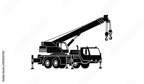 A heavy duty mobile crane truck with an extended telescopic boom and dual lifting hook assembly