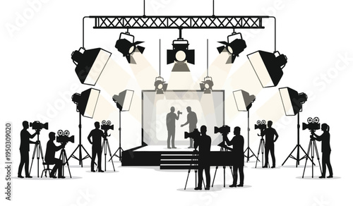 A professional television studio production set with camera operators filming two people on stage