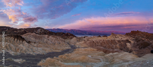 Zabriskie Point, Death Valley: Badlands glow under vibrant sunset.