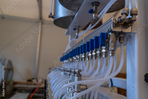Horizontal view of industrial pneumatic valves and air distribution system
