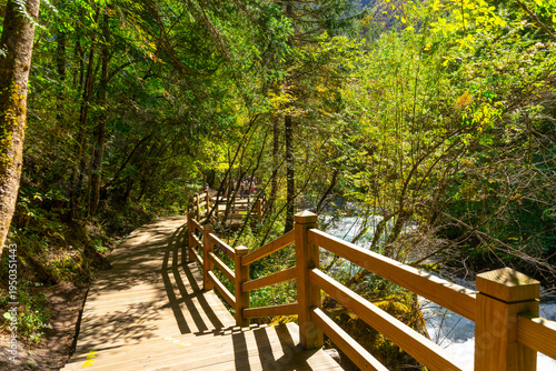 The wooden hiking path runs along Pearl Shoal Falls, Jiuzhaigou National Park, Sichuan, China.
