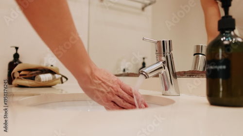 Hand Washing At Bathroom Sink With Faucet