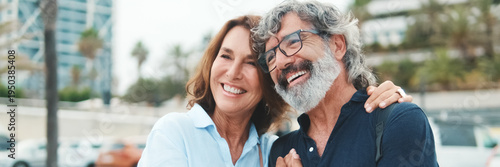 Photography Close-up of an elderly couple standing on the embankment and looking at each other with smile