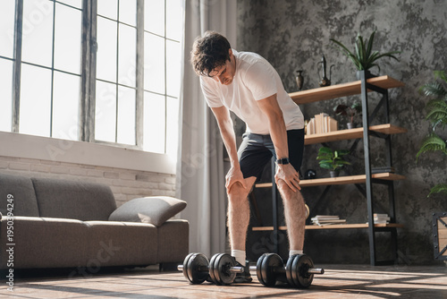 Home, fitness man rest with weights for workout, strength development muscle training for health goals. Challenge, bicep curl or active athlete with arm exercise, body building or dumbbells for gain