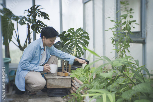Sustainable urban gardener repurposing spent coffee grounds as organic fertiliser for fresh leafy greens. Eco-friendly DIY composting recycling food waste the growing trend of home vegetable farming.