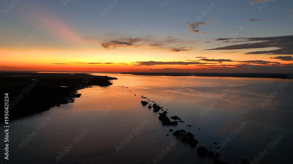 Naklejka premium Colorful Sunset In Manaus Amazonas Brazil. Capturing The Effects Of Flooding In The Amazon Rainforest. Sunset Savage Nature Forests Shore. Forest. Manaus Amazonas.