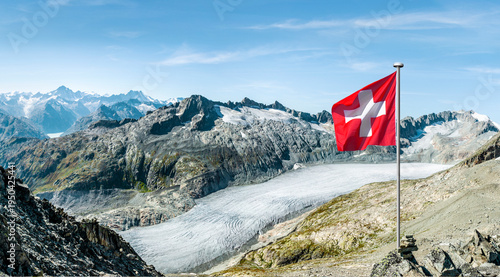 Swiss mountain panorama at the Rhone Glacier with Swiss national flag