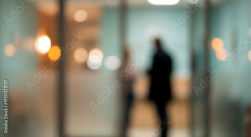 Wallpaper Mural A blurred image depicting two people engaging in a conversation, with soft lighting creating a warm atmosphere, suggesting a professional or casual setting. Torontodigital.ca