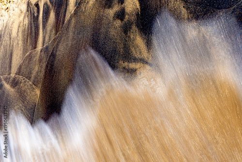 Abstract motion blur wave washing over sand on Lake Michigan beach