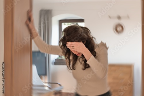 Blured photo of a woman suffering from vertigo or dizziness or other health problem of brain or inner ear.
