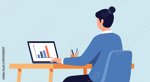 Person with a bun at a desk working on a laptop with a bar graph