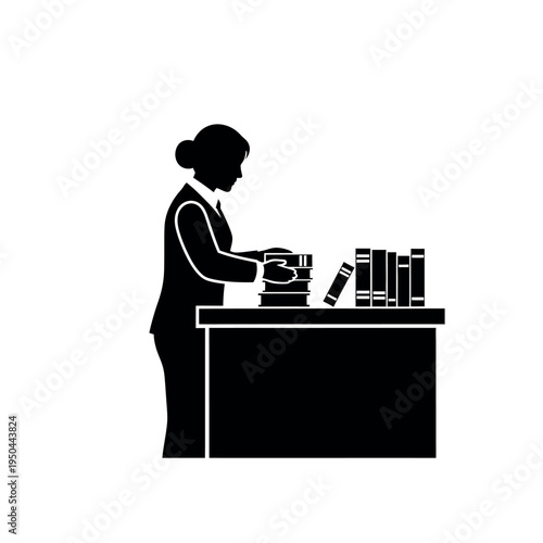 Woman arranging books on a desk.