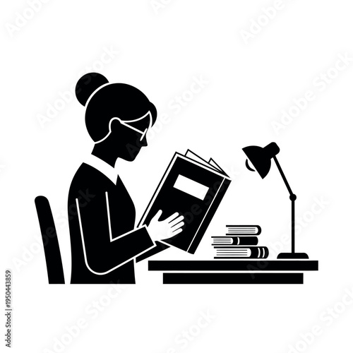 Woman reading book at desk with lamp and books.
