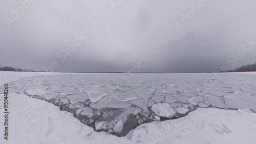 Frozen Lake Ontario Ice Sheets at Cherry Beach Toronto During Winter, Cracked Ice Patterns Across Frozen Water Under Dramatic Overcast Sky