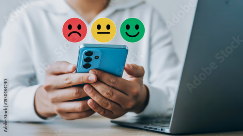 Person holding phone with emotions floating on top