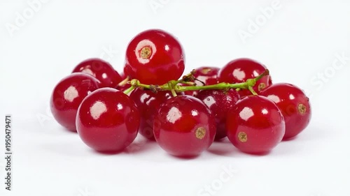 A cluster of juicy red cherries sits on a clean white surface, perfect for still life  or food styling