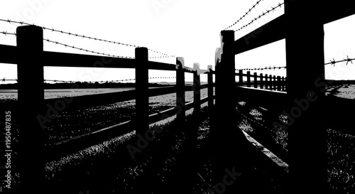 Silhouette of wooden fence with barbed wire against a bright sky rural scene