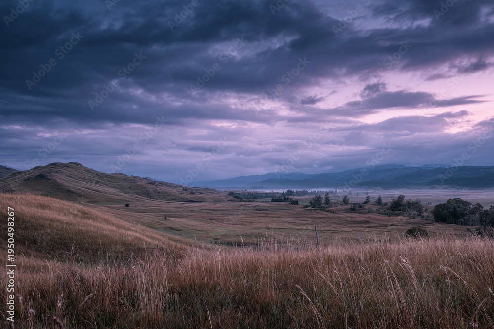Obraz premium Atmospheric hill landscape at dusk with dramatic overcast sky in Esquel, Patagonia