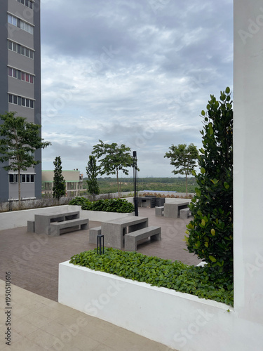 Outdoor concrete picnic and dining area in modern apartment complex. 