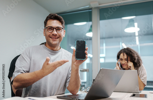 Selfassured Individual Illustrating Application Features To Colleague In Contemporary Office Setting