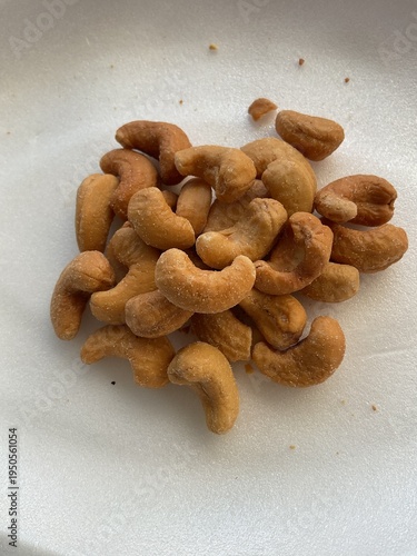 Roasted cashew nuts with salt, healthy snack on white background