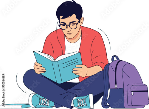 Focused male student wearing glasses reads textbook while sitting cross-legged