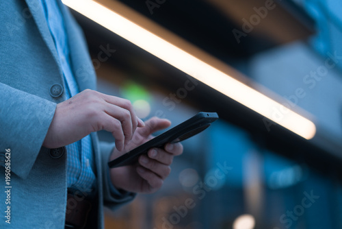 Foto Business professional holding and operating a smartphone in close-up shot
