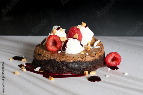 Classic American Brownie with whipped cream and fresh raspberries