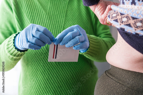 Detail of opening an envelope containing a fentanyl patch.