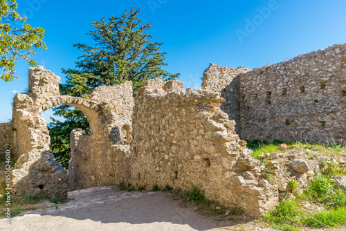 Arched entrance to the Mystras archeological site and byzantine town with ruins of fortification wall, Laconia, Peloponnese, Greece