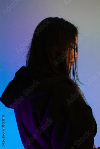 Moody cyberpank portrait of  brunette woman in neon blue and teal light, cinematic red lips