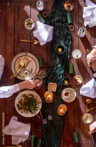 High angle view of people having a dinner party with drinks and food in a formal setting.